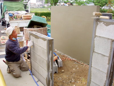積み上げたブロックに左官で塗装の下地作りをしていきます。